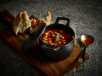 Mini Cast Iron Casserole Dish with food and on a paddle board